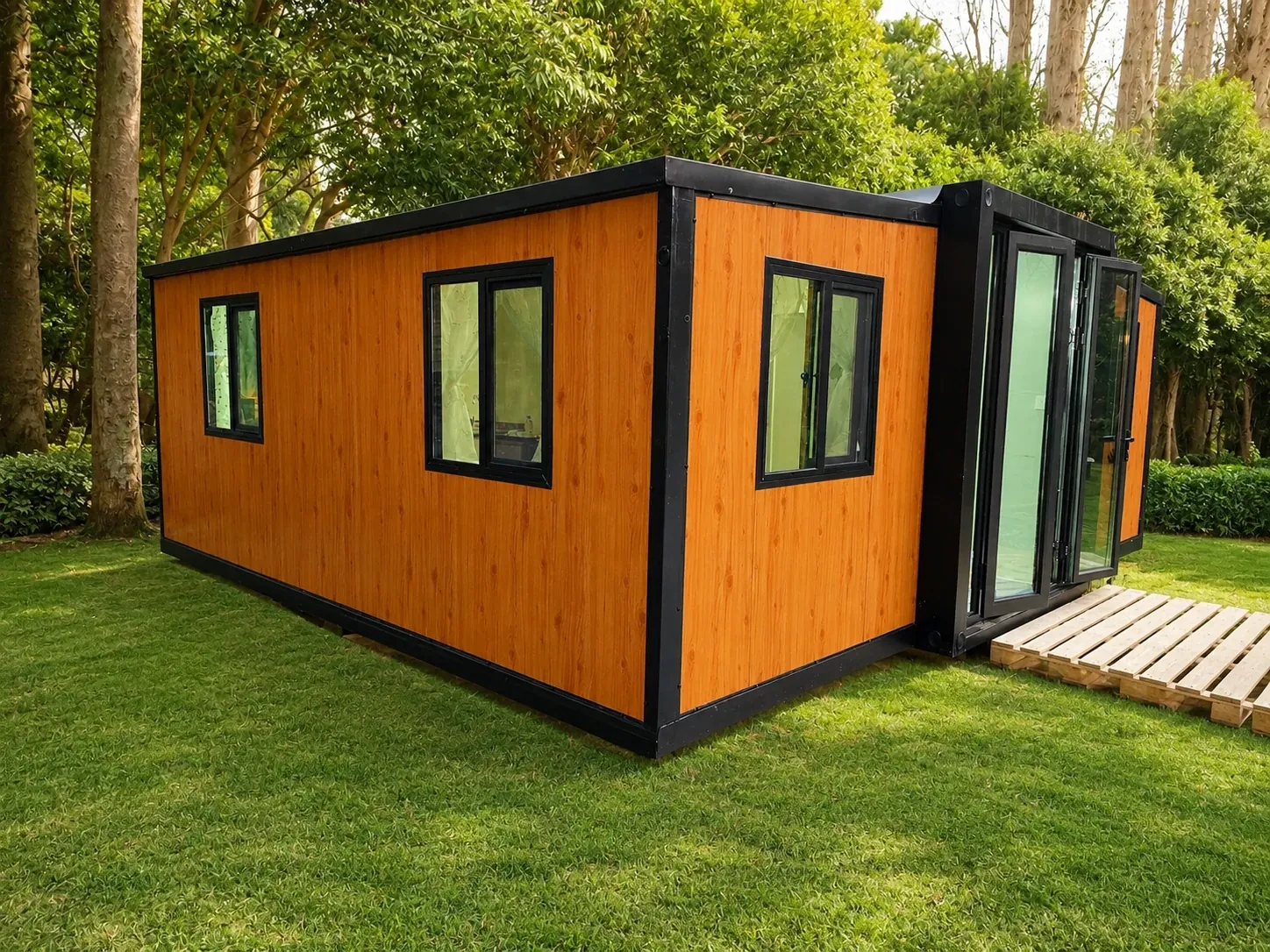 Side view of a wood-clad 20 ft expandable home standing on a lawn